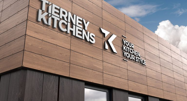 Tierney Kitchens sign on a timber-clad building, "Your kitchen, your style"