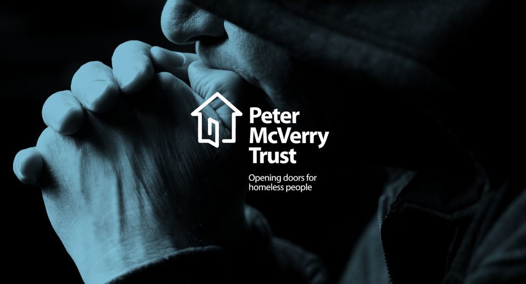 Peter McVerry Trust logo over a photograph of clasped hands