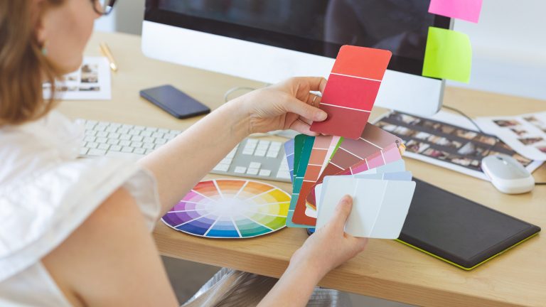 Designer checking a colour swatch for a brand style guide