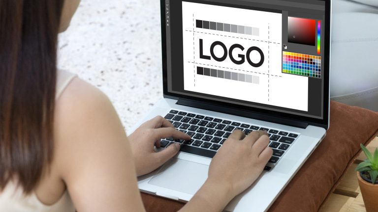 Designer sketching logo ideas, common branding mistakes to avoid