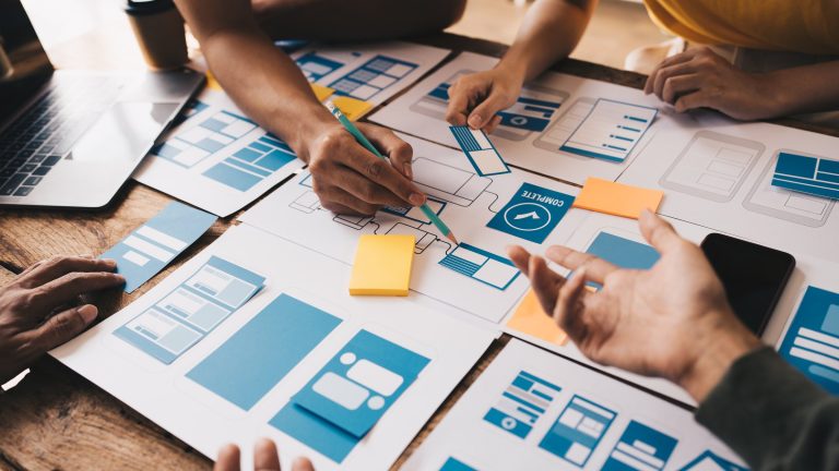 Designers reviewing a client brief and colour codes: how to brief a branding agency