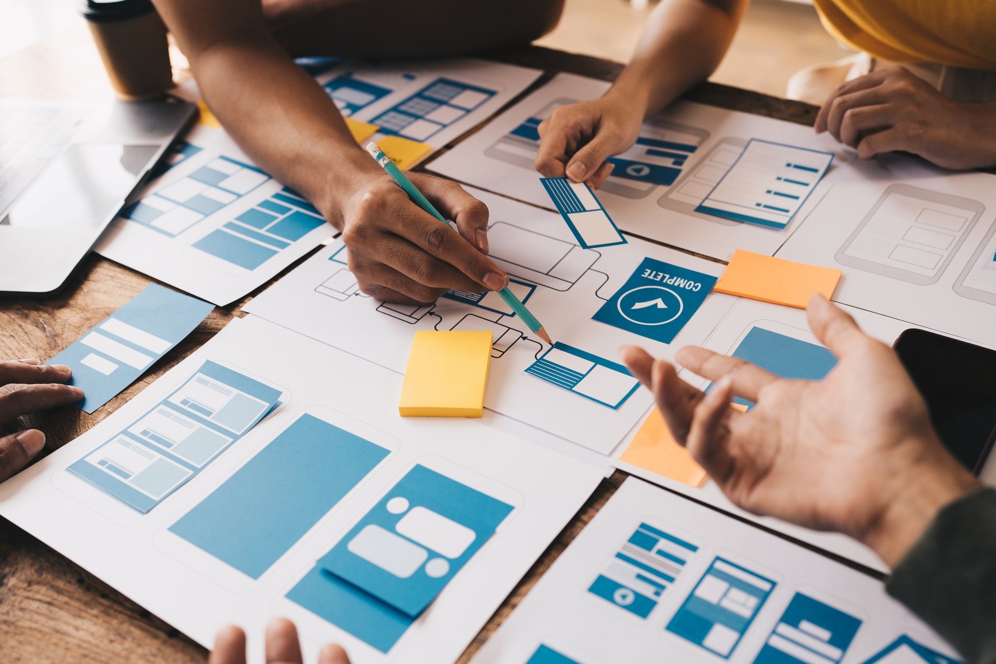 Designers reviewing a client brief and colour codes: how to brief a branding agency